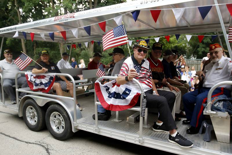 Veteran wave from a float on Sunday, July 7, 2024, during Crystal Lake’s annual Independence Day Parade on Dole Avenue in Crystal Lake. This year’s parade feature close to 100 units.