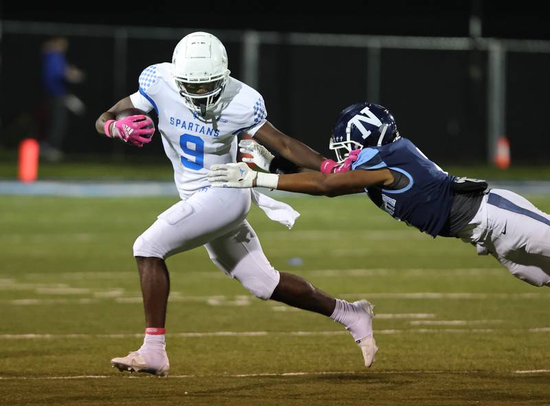 St. Francis’ DeShaun Williams (9) breaks a tackle against Nazareth during the boys varsity football game on Friday, Oct. 20, 2023 in La Grange Park, IL.