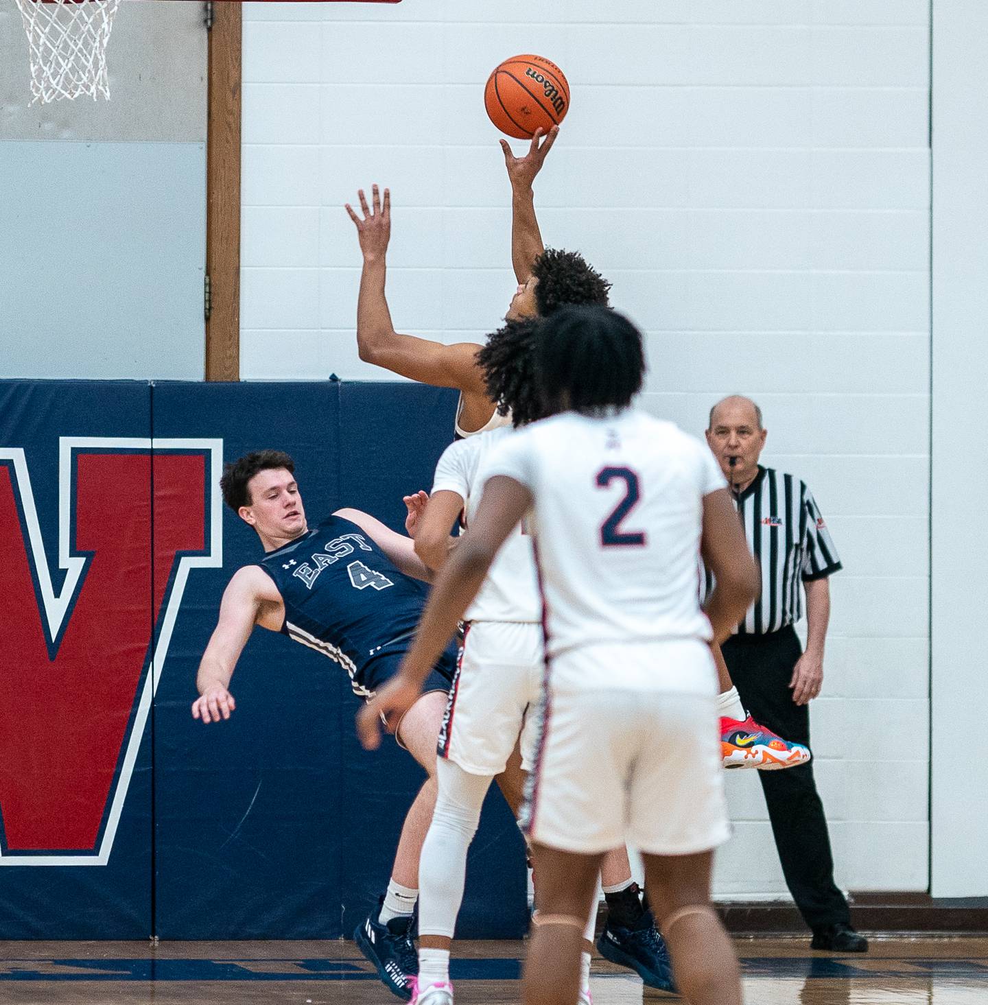 Oswego East's Tyler Jasek (left) holds his ground to draw charge against West Aurora's Joshua Pickett during a basketball game at West Aurora High School on Friday, Jan 27, 2023.