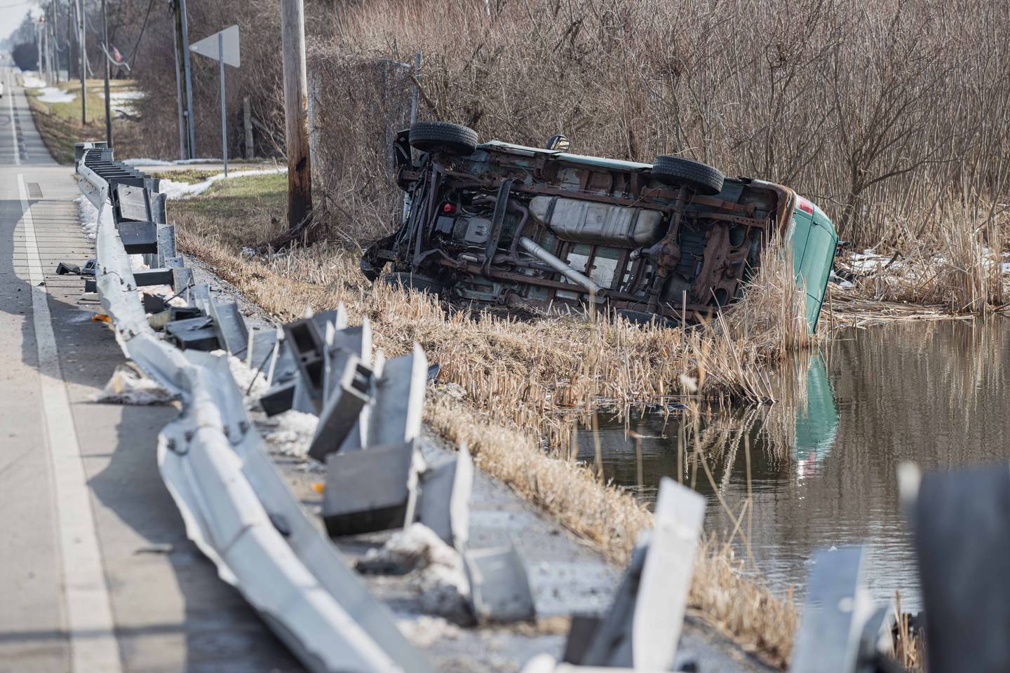 A car sheared off approximately 150 feet of guardrail along Hartland Road near Woodstock before rolling into a marsh area on March 19, 2026.