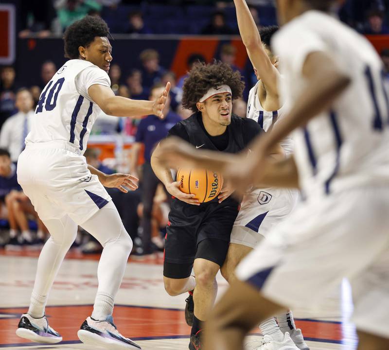 Benet's Jayden Wright (3) drives the lane against DePaul College Prep during the IHSA Class 4A boys basketball state semifinal Friday, March 13, 2026 at the State Farm Center in Champaign.