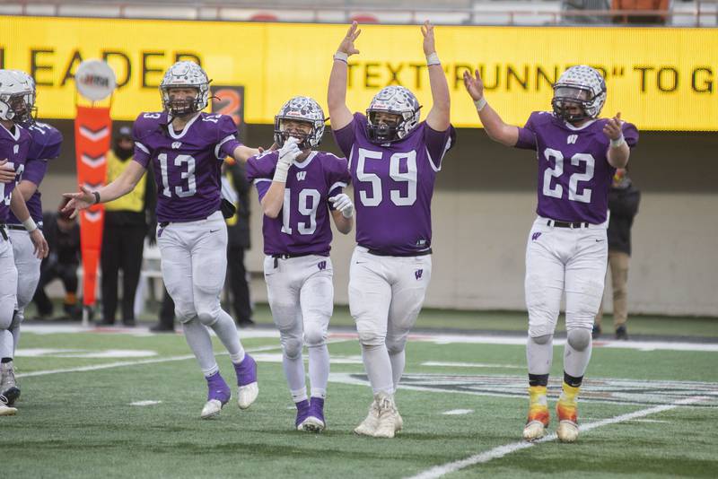 Wilmington's Jacob Friddle (left), Colin James, Dominic Dingillo and Karsen Hansen celebrate their win in the Class 2A state championship game Friday, Nov. 26, 2021.