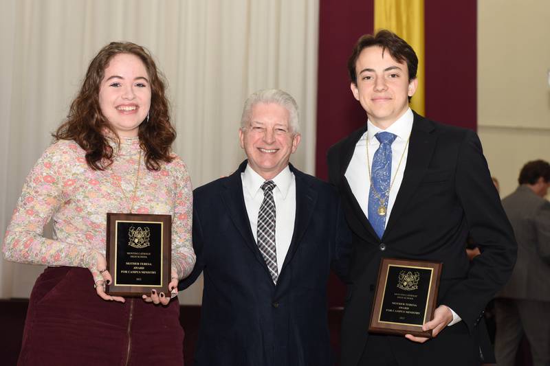 Montini Catholic High School seniors Julia Moran and James Stiso hold their awards, next to Campus Minister Michael Blanchette at Founder's Day 2022.
