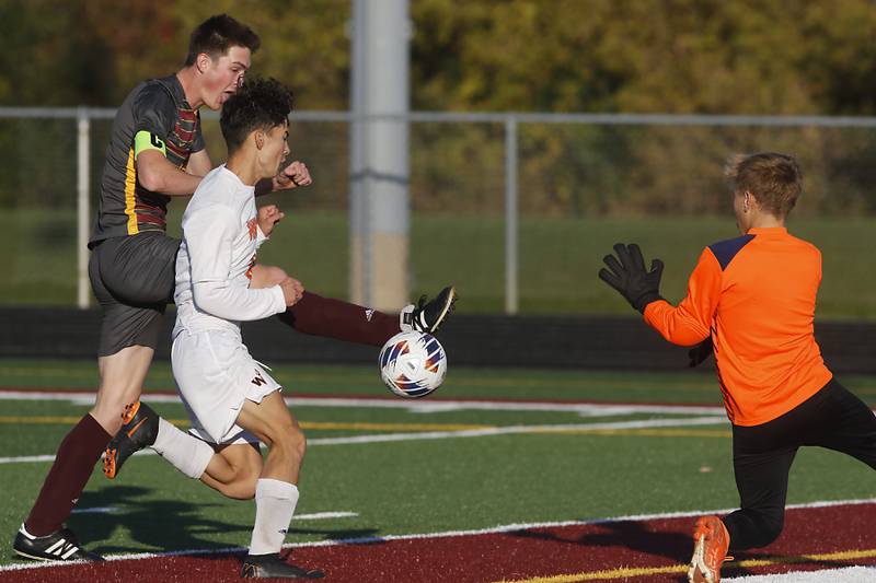 Richmond-Burton's Sean Rockwell kicks the ball into goal past Winnebago's Noah Melin as Wyatt Webb tries to defended during the IHSA Class 1A Richmond-Burton Regional Final soccer match Tuesday, Oct. 17, 2023, at Richmond-Burton High School in Richmond.