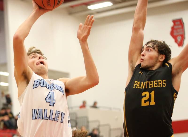 Bureau Valley's Landon Hulsing eyes the hoop as Putnam County's Orlando Harris defends during the 49th annual Colmone Class on Thursday, Dec. 7, 2023 at Hall High School.