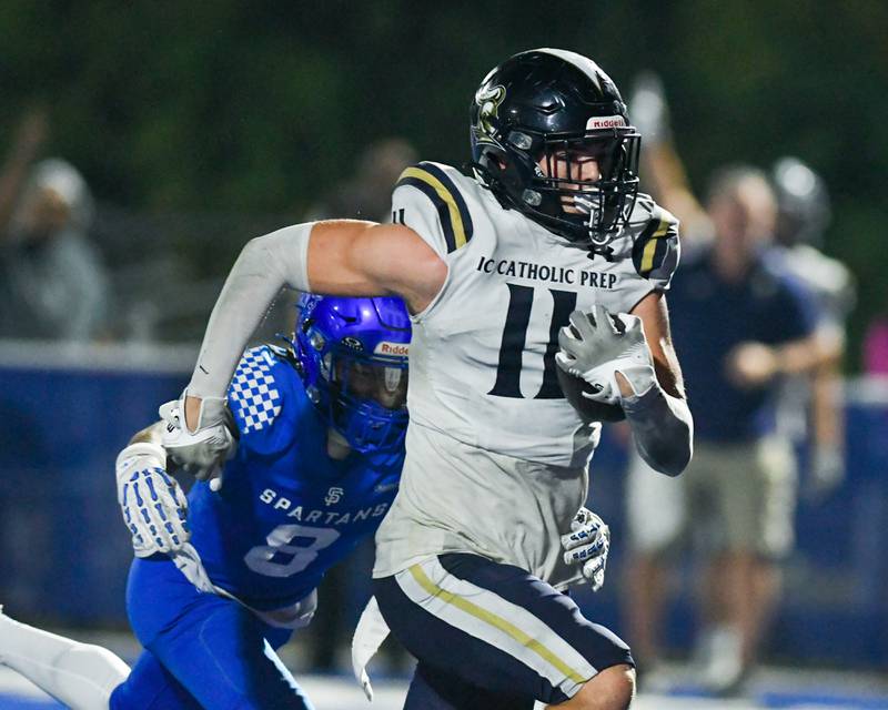 IC Catholic Prep's Grant Bowen (11) runs the ball while being defended by St. Francis's Preston Shipley (9) during the game on Friday Oct. 3, 2025, held at St. Francis High School.