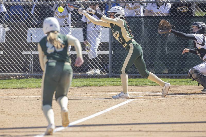 St. Bede's Lily Bosnich (right) lays down a sacrifice bunt to score the first point of the day for the team on Saturday, April 8, 2023 at St. Bede Academy