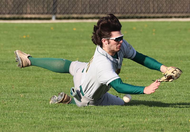 Waubonsie Valley's Jack Roberts tries to make a diving catch in left field Monday, April 20, 2026, during their game at DeKalb High School.