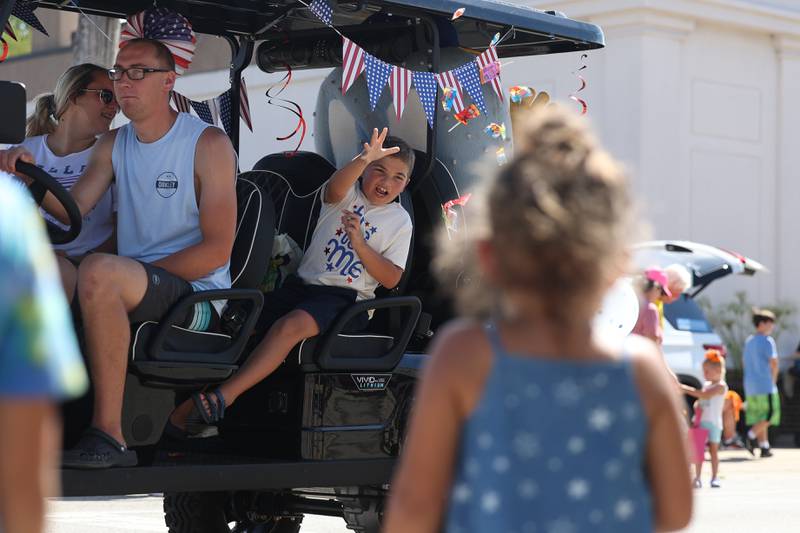 A kid throws out candy to the crowds in the Manhattan Labor Day Parade on Monday, Sept. 4, 2023 in Manhattan.