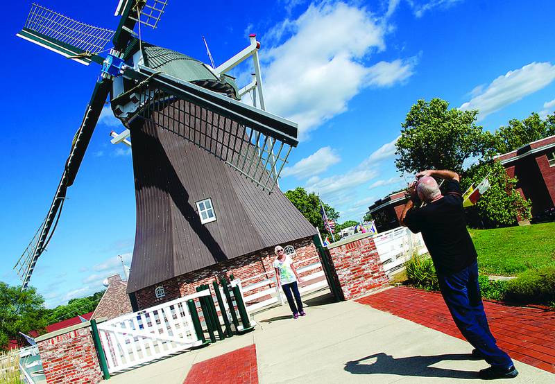 Sandy Muller has her picture taken by husband, Derek, as the two toured the de Immigrant Windmill in Fulton. The tourists from Brisbane, Australia, are in the area for the next few days.
