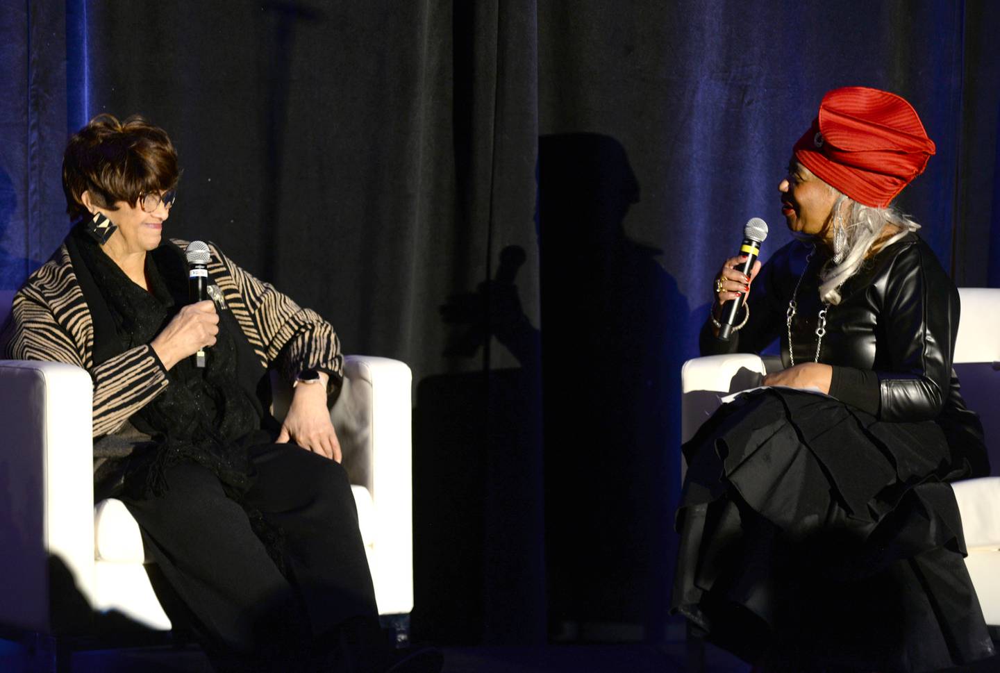 Regina Brent (left), founder of Unity Partnership and co-chair of the DuPage County MLK Executive Committee, talks Tuesday with Civil Rights pioneer Dorothy Counts-Scoggins about her experience at Harry P. Harding High School during the school's integration at the Dr. Martin Luther King Jr. Unity Breakfast