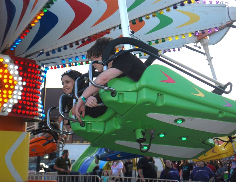 Carnivalgoers take advantage of the rides filling Hickory Street during the opening night of Streator Park Fest on Friday, May 26, 2023.