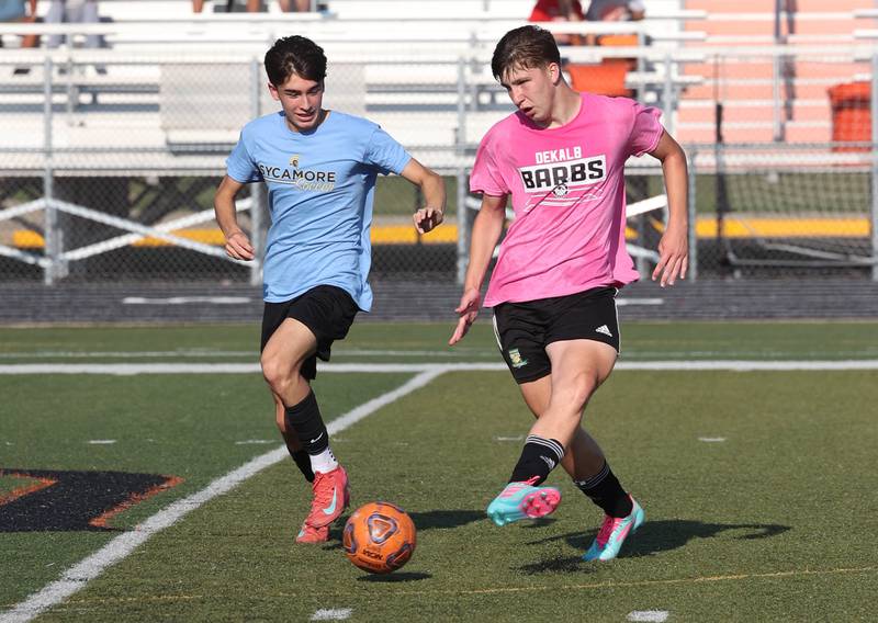 DeKalb’s Jack McCormick kicks the ball by a Sycamore player Monday, July 14, 2025, during a summer boys soccer friendly at DeKalb High School.
