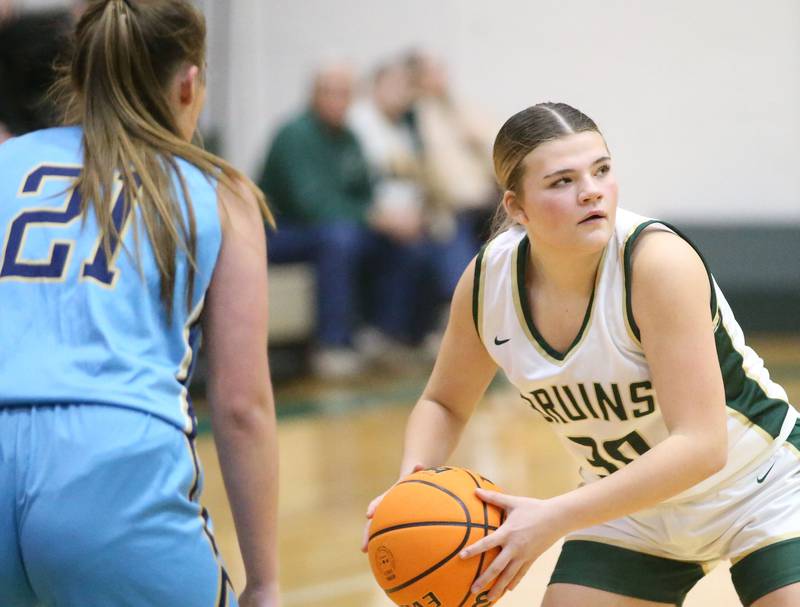 St. Bede's Angie Bartlett passes the ball off as Marquette's Kinley Rick defends on Monday, Dec. 2, 2024 at St. Bede Academy.