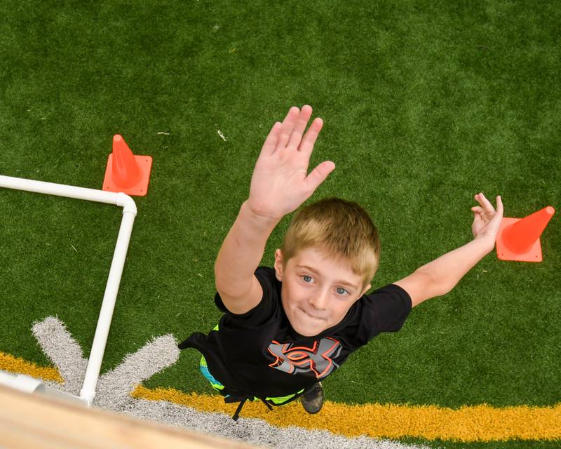 Ben Keely of Downers Grove sees how high he can get in the standing vertical jump portion of the NFL Youth Flag Football Combine Day held at Doerhoefer Park in Downers Grove on Sunday Aug. 6, 2023.