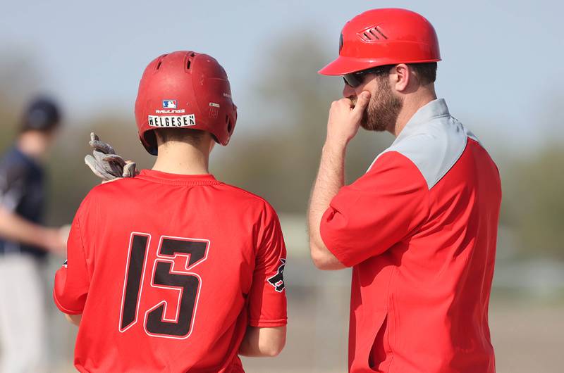 Indian Creek's Kalab Helgesen gets some advice from head coach Kevin Poterek during their game against IMSA Monday, May 9, 2022, in Shabbona.