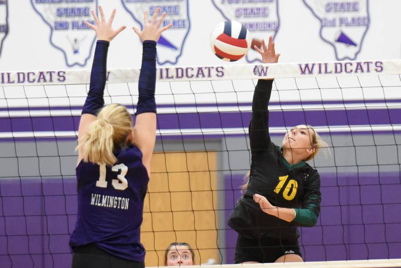 Coal City's Ava Kenney, right, looks to hit the ball past Wilmington's Taryn Talley during a game at Wilmington Thursday, Sept. 25, 2025.