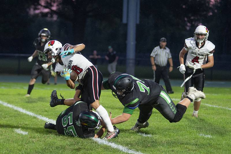 Rock Falls’  Jason McCord (right) helps pull down Stillman Valley’s Porter Needs Friday, Sept. 2, 2022.