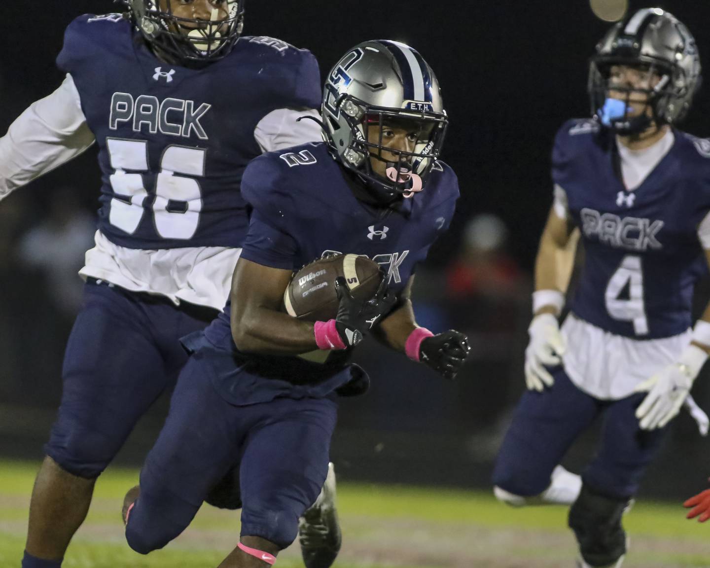Oswego East's Jasiah Watson (2) looks for running room during football game between Yorkville at Oswego East Friday, Oct 10, 2025 in Oswego.