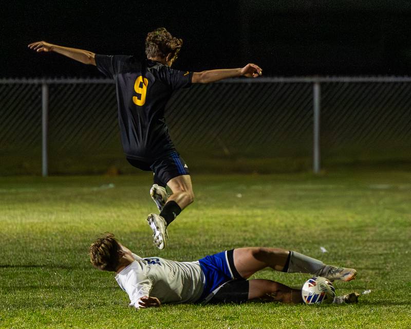 (9) of Somonauk/Leland/Newark jumps over Luke Badal (23) of Hinckley-Big Rock after he trips in the fight of possession during the Little Ten Conference Championship match on Thursday, Oct. 9, 2025 at Hinckley-Big Rock School in Hinckley.