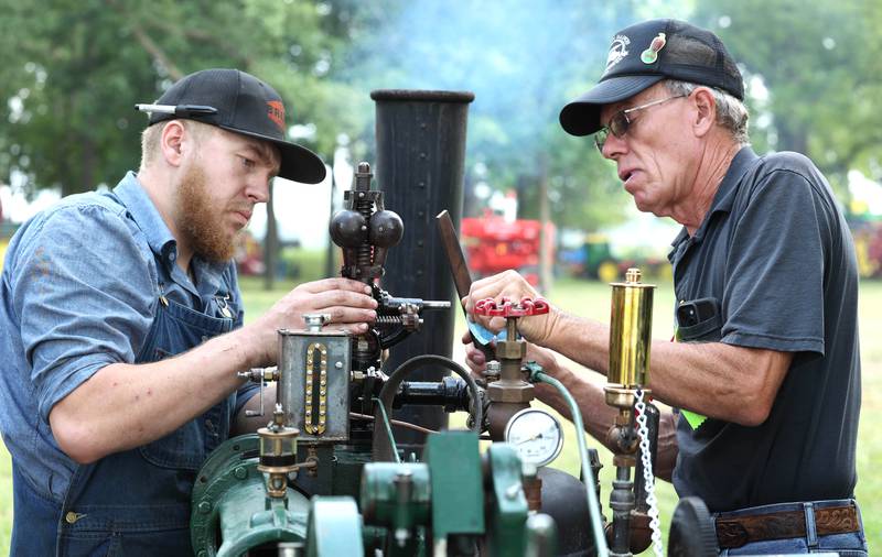 Jack Stuffle, (left) from Hinckley, and Dave Stevens, from Sycamore, work on a half-scale 65 horsepower Case steam tractor during the Sycamore Steam Show Thursday, Aug. 10, 2023, at Taylor Marshall Farm in Sycamore. The show runs from 7 a.m. to 5 p.m. through Sunday.