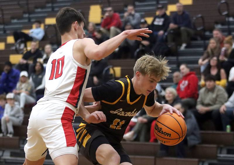 Jacobs’ Carson Goehring moves the ball against Barrington during Hinkle Holiday Classic varsity boys basketball tournament action on Monday, Dec. 23, 2024 at Jacobs High School in Algonquin.