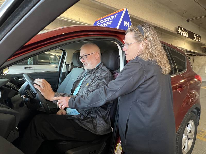 Dan Davis practices turning a modified steering wheel with assistance from Karyn Silvestri, driver rehabilitation specialist, at Northwestern Medicine Marianjoy Rehabilitation Hospital's Driver Rehabilitation Program.