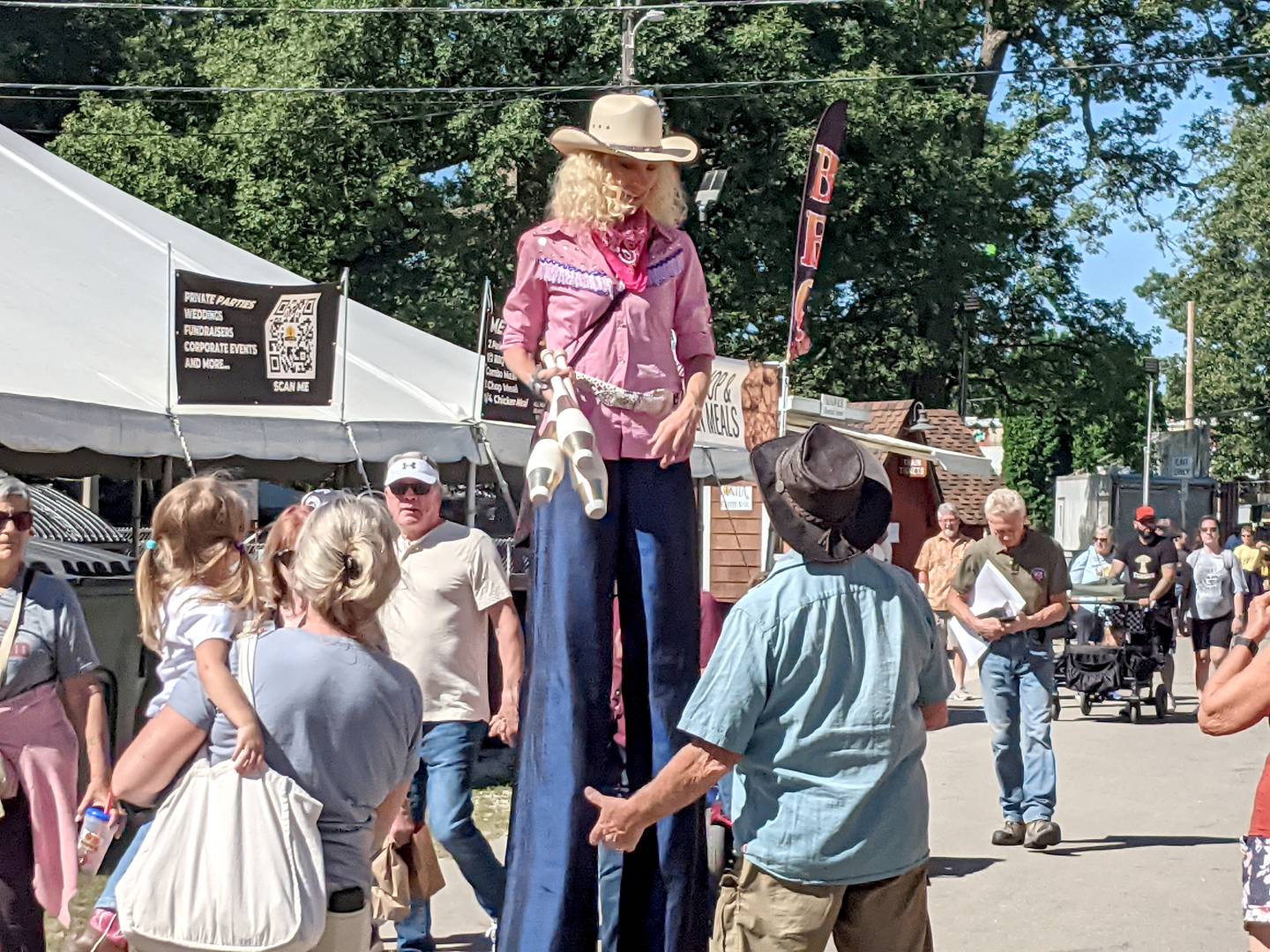 Carrie McQueen, known as the Ultimate Stilt Walker, greets visitors Sept. 4, 2024, at the Sandwich Fair.