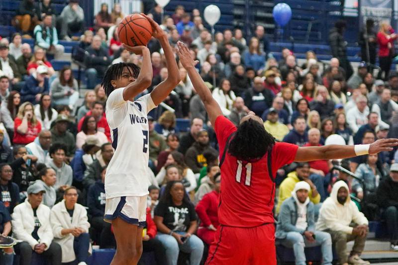 Oswego East's Mason Lockett IV (2) shoots a three pointer against West Aurora's Jordan Brooks (11) during a basketball game at Oswego High School on Friday, Feb 2, 2024.