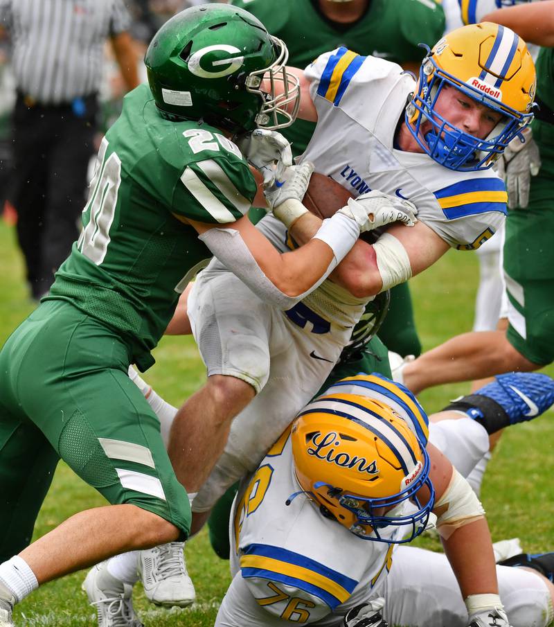 Lyons Township's Danny Caroll is stopped just short of the goal line by Glenbard West's Joey Campanella  (20) during a game on Sep. 16, 2023 at Glenbard West High School in Glen Ellyn.