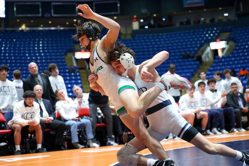IC Catholic's Drew Murante, right, takes down Providence Catholic's Christian Corcoran in the 113-pound match during IC Catholic's victory in the IHSA Class 2A Dual Team State championship on Saturday, Feb. 28, 2026.