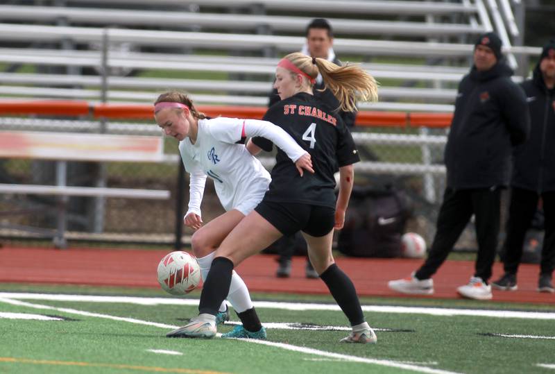 Burlington Central’s Kendall Grigg (left) and St. Charles East’s Presley Kannaka battle for the ball during a game on Tuesday, April 1, 2025 in St. Charles.