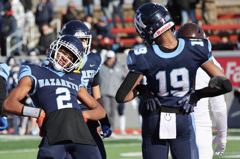 Nazareth's Trenton Walker (right) celebrates his touchdown with Nazareth's Garrett Reese Saturday, Nov. 25, 2023, during their IHSA Class 5A state championship game against Joliet Catholic in Hancock Stadium at Illinois State University in Normal.