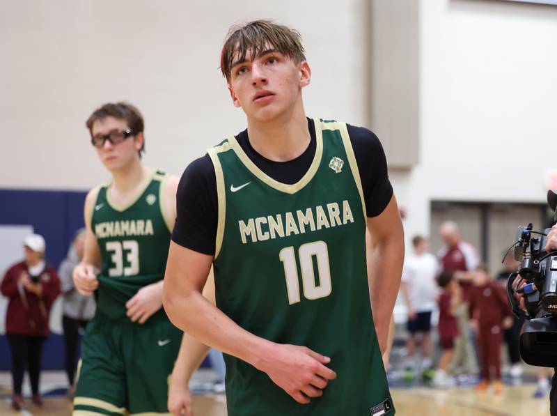 Bishop McNamara's Coen Demack and Callaghan O'Connor, left, look to the scoreboard as they leave the court following the Fightin' Irish's 77-70 loss to Tolono Unity in the IHSA Class 2A Pontiac Supersectional on Monday, March 9, 2026.