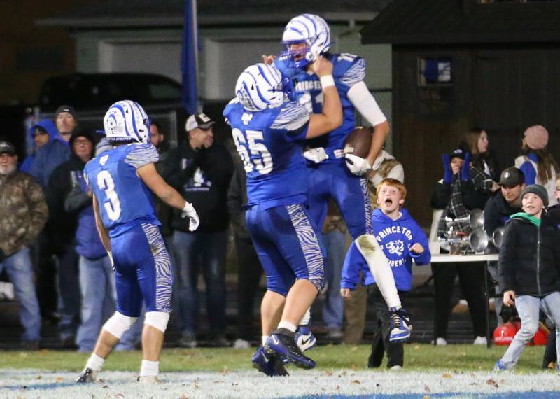 Princeton's Noah LaPorte celebrates with teammate Cade Odell and Ace Christiansen after scoring a touchdown against Oregon during the Class 3A playoff game on Friday, Nov. 1, 2024 at Princeton High School.