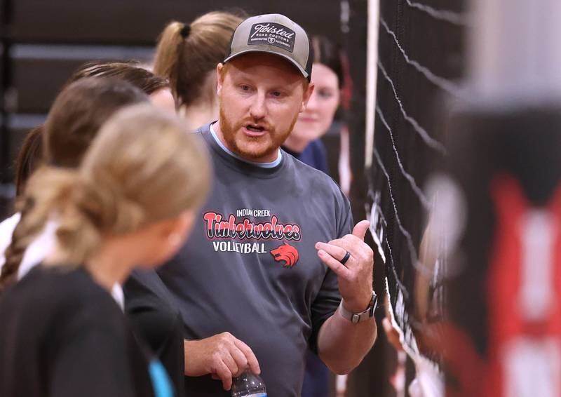 Indian Creek head volleyball coach Matthew Orstead explains a drill to his team during practice Tuesday, Aug. 13, 2024, at the school in Shabbona.