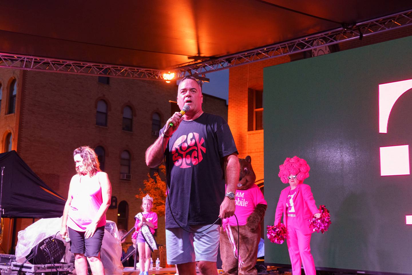 Woodstock Mayor Mike Turner on stage during the Rockstock concert event in downtown Woodstock on Saturday, Aug. 28, 2021, to help announce the city will receive $3 million in prizes from T-Mobile as the top winner of an inaugural grant contest held by the company.