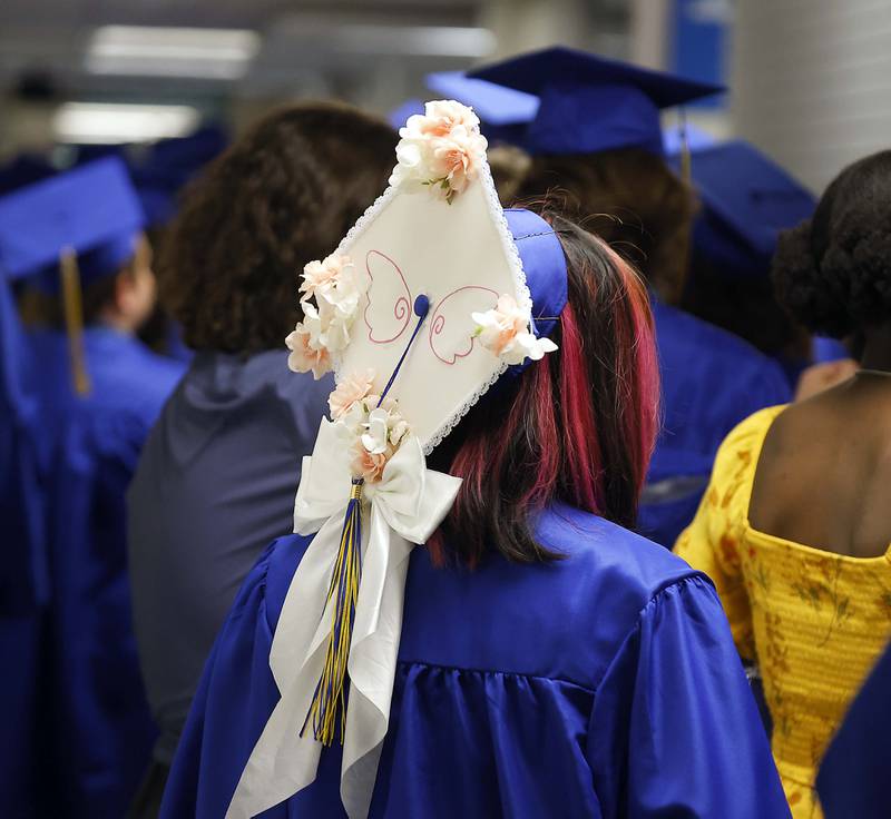 A Wheaton North High School graduate wears an decorated mortar board during the graduation ceremony Saturday, May 25, 2024 in the Physical Education Center of College of DuPage in Glen Ellyn.