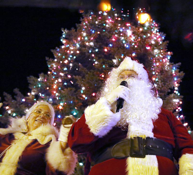 Santa and Mrs. Claus talk to the crowd in front of the tree after lighting the Christmas lights at the DeKalb County Courthouse during Walk With Santa Friday, Dec. 3, 2021, in downtown Sycamore.