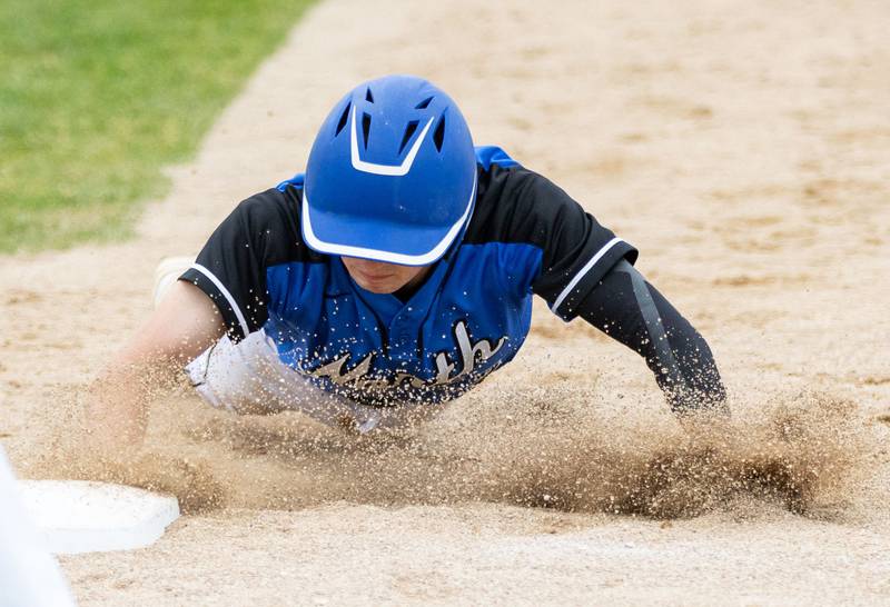 St. Charles North’s Tyler Gleason slides into first during a pickoff attempt during the Class 4A Regional semifinal against Batavia at Batavia High School in Batavia on Thursday, May 29, 2025.