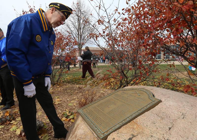 Veteran Jim Dabler, looks at the memorial rock of 24 Hall High School veterans that died in WWII during the Veterans Day program on Tuesday, Nov. 11, 2025 at Hall High School.