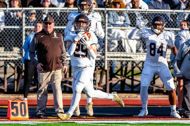 Joliet Catholic Accademy's Keegan Farnaus catches a pass and continues to run in a touchdown during the 5A Quarterfinals game on Saturday Nov. 11, 2023 at Morris High School