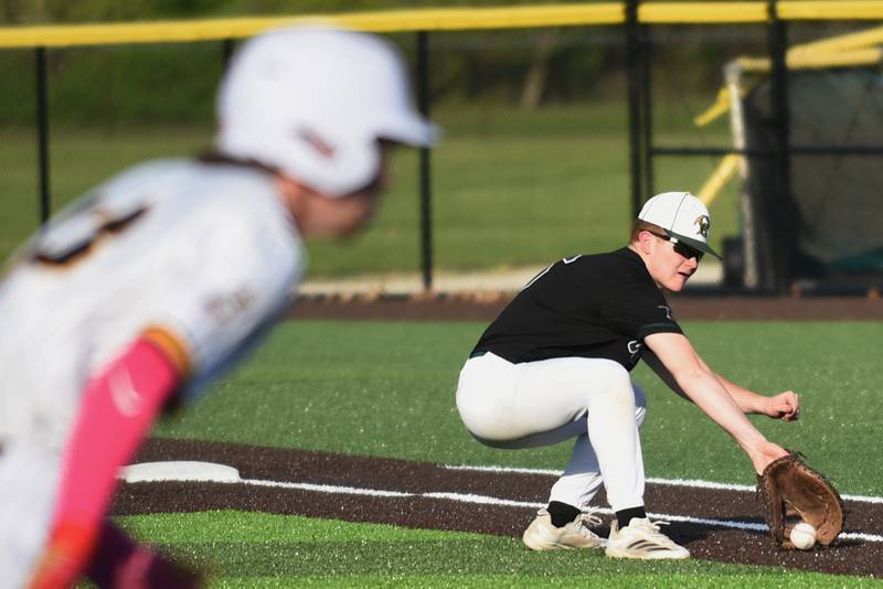 Coal City's Ethan Olson, right, fields a squeeze bunt as Reed-Custer's Alex Bielfeldt heads to home for the go-ahead run in the sixth inning of the Comets' 4-3 win at home Tuesday, May 6, 2025.