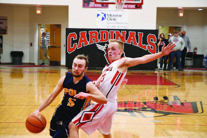 Polo’s Trevin Woodin (5) drives around Forreston’s Braedon Fyock during their NUIC East matchup Thursday night in Forreston. Woodin was one of five Marcos to score in double figures in Polo’s 68-51 victory.