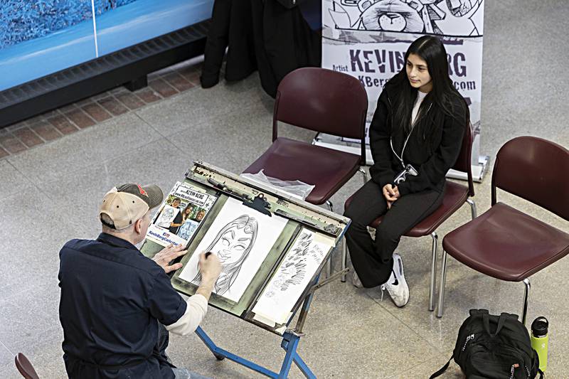 Diana Ramirez of Sterling has her caricature drawn by Kevin Berg on Monday, Jan. 22, 2024, at Sauk Valley Community College.