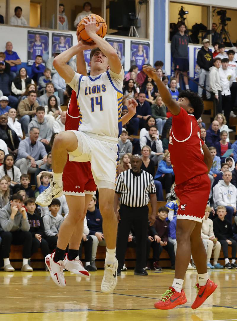 Lyons Township's Grant Smith (14) puts up a shot during a varsity basketball game between Hinsdale Central and Lyons Township high schools on Friday, Dec. 12, 2025 in La Grange.