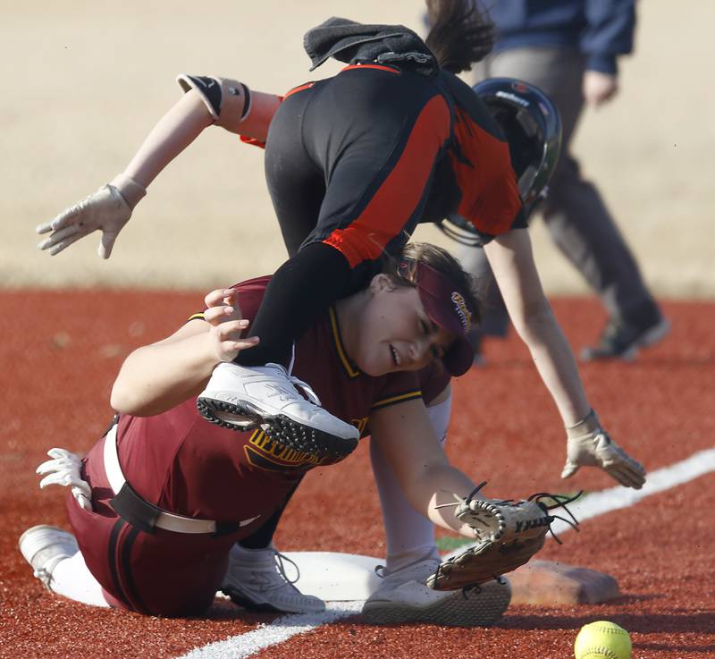 Richmond-Burton's Norah Spittler tries to get the ball as Crystal Lake Central's Gianna Carone tries to get to first base during a nonconference softball game Wednesday March 16, 2022, between Crystal Lake Central and Richmond-Burton at Lippold Park in Crystal Lake.