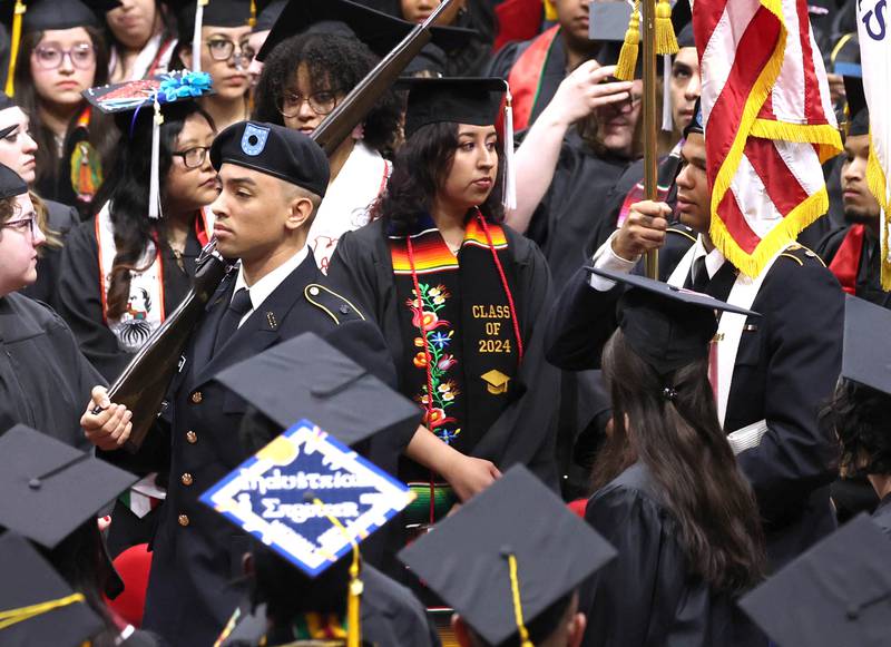The Northern Illinois University ROTC Color Guard walks the colors past candidates for graduation during the first of two undergraduate commencement ceremonies Saturday, May 11, 2024, in the Convocation Center at NIU in DeKalb.