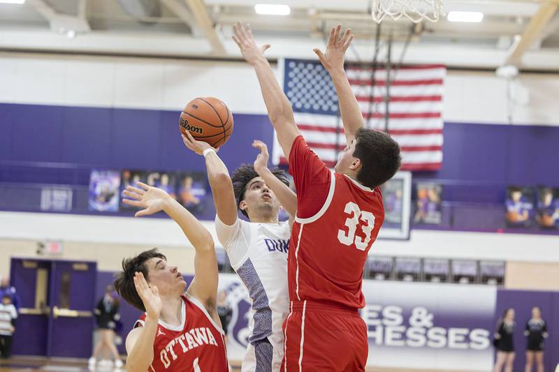 Dixon’s Wyatt Wetzell puts up a shot against Ottawa’s Cooper Knoll Wednesday, Feb. 22, 2023 during a 3A sectional semifinal game.