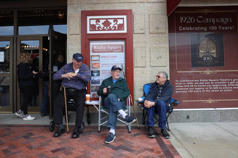 Andy Honiotes, left, Ron Clausing and Bob Murphy, for the Joliet chapter of the Ford Model A Restorers Club, sit outside the Rialto Theater during the theaters 100th anniversary celebration on Sunday, May 3, 2026 in Joliet.